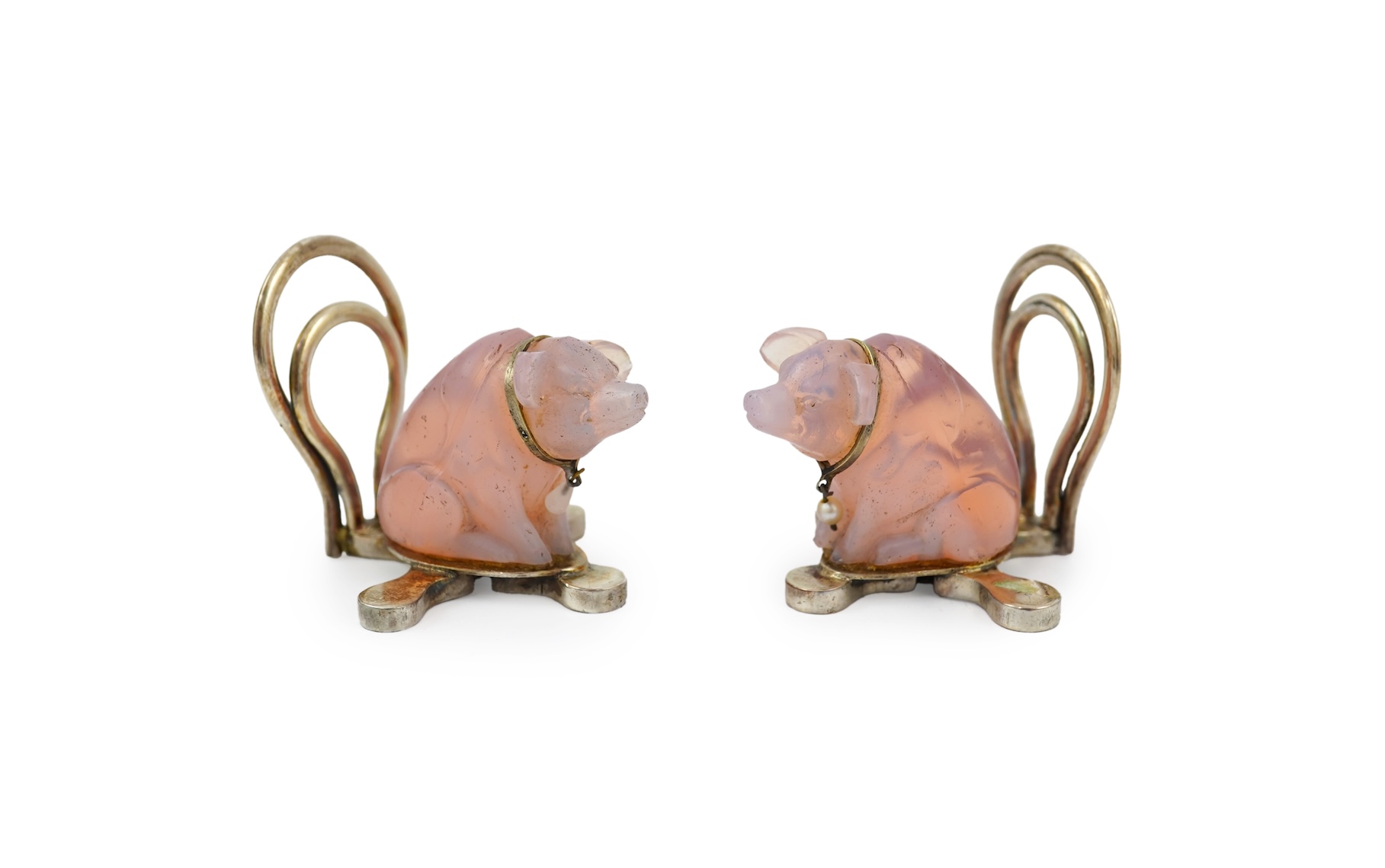 A cased pair of unusual Edwardian silver and pink glass mounted menu holders, by William Comyns, each modelled as a seated pig with collar
